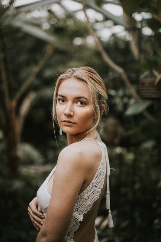 Full-length portrait of Morgan styled among greenhouse greenery