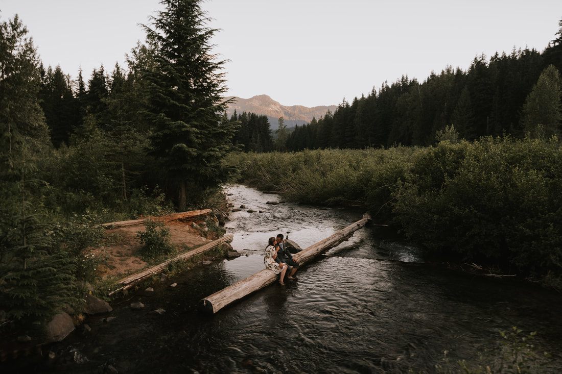 Jesse and Yanah embracing in the Snoqualmie Valley scenery