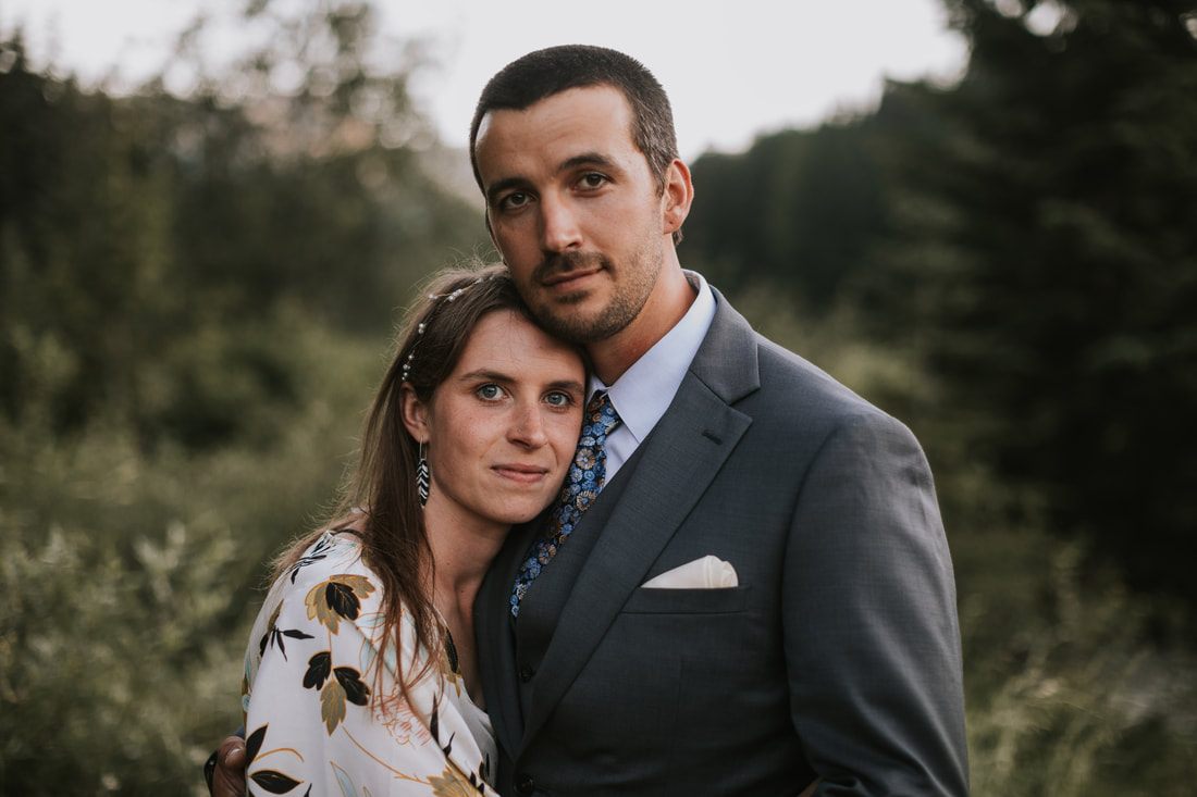 Portrait of the couple silhouetted against the valley landscape