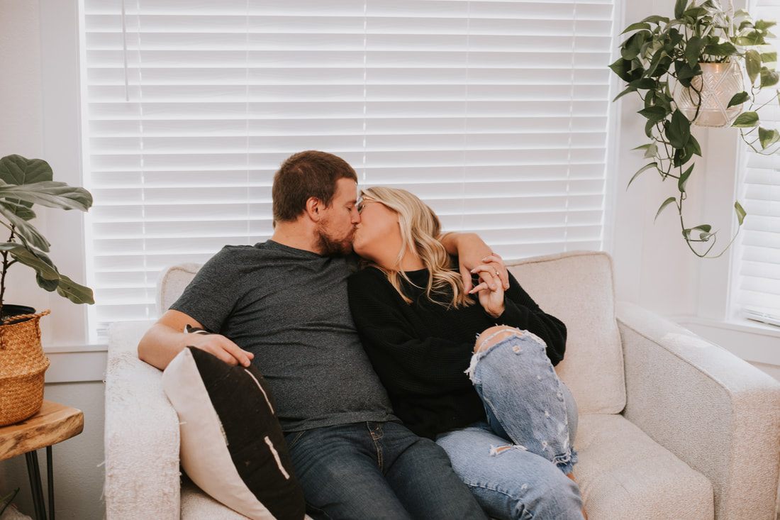 Engaged couple sitting together in their North Bend backyard