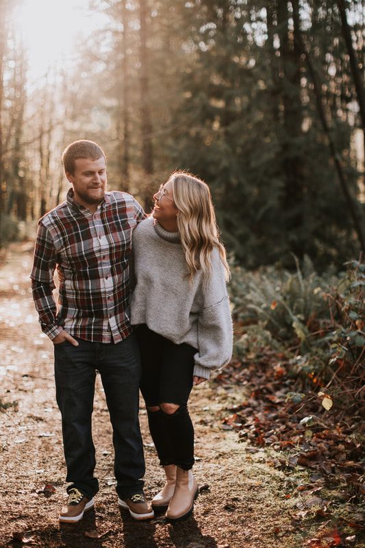 Couple laughing together as they walk through their backyard