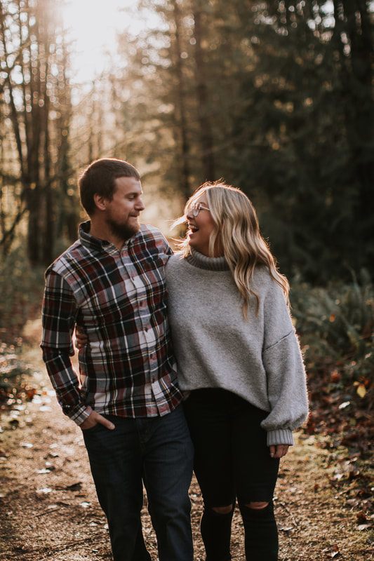 Candid moment of the couple embracing near the water