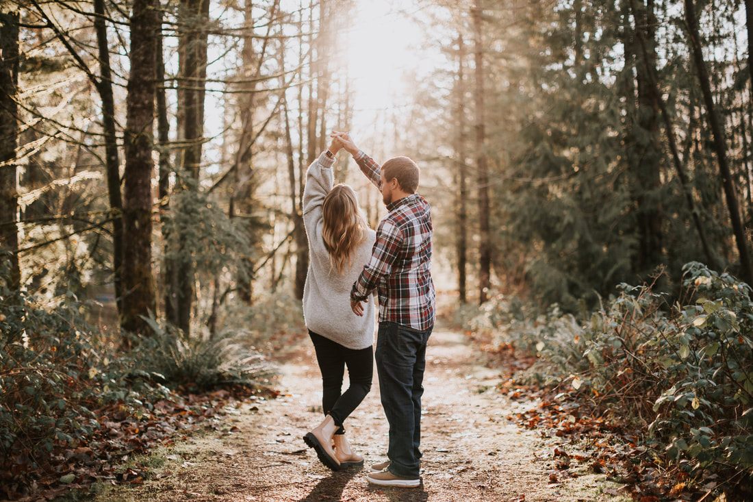 Close-up portrait of the couple foreheads together near the river