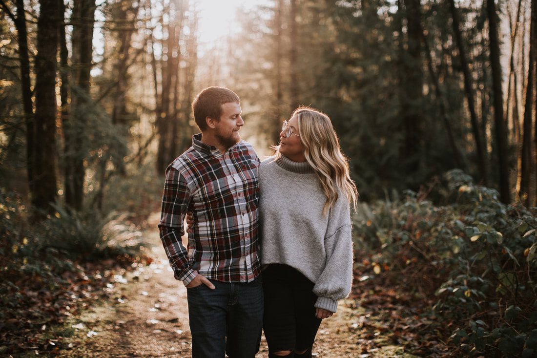 Engagement portrait backlit by the setting sun over the mountains
