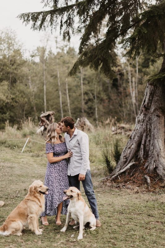 Close-up portrait of an engaged couple in front of a barn