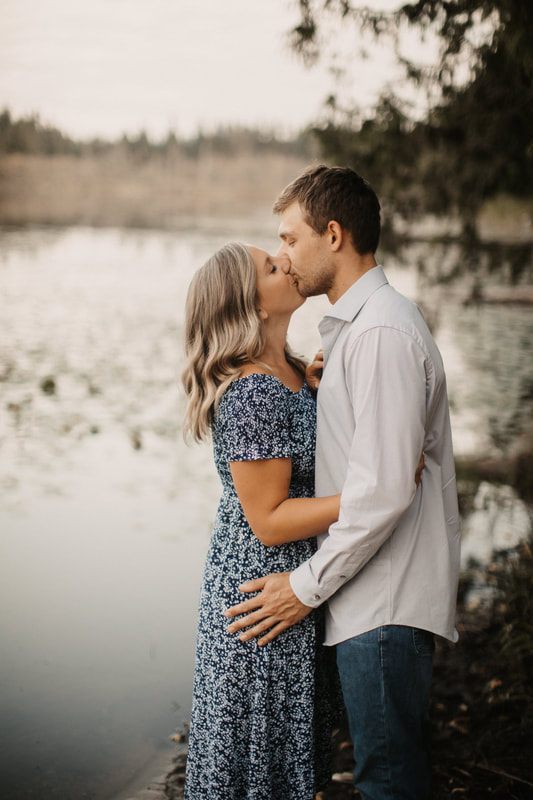 Couple embracing with farmland stretching out behind them