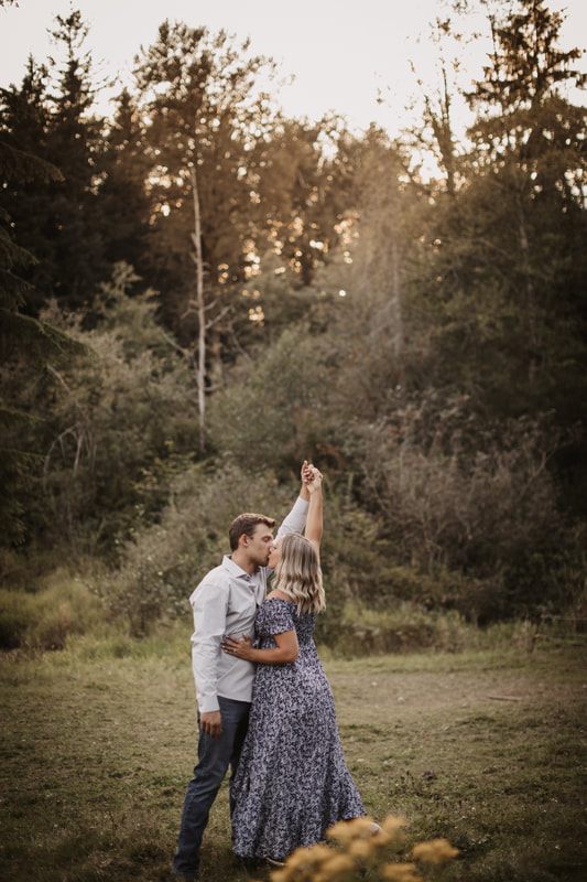Engaged couple walking a dirt path on their Snohomish farm
