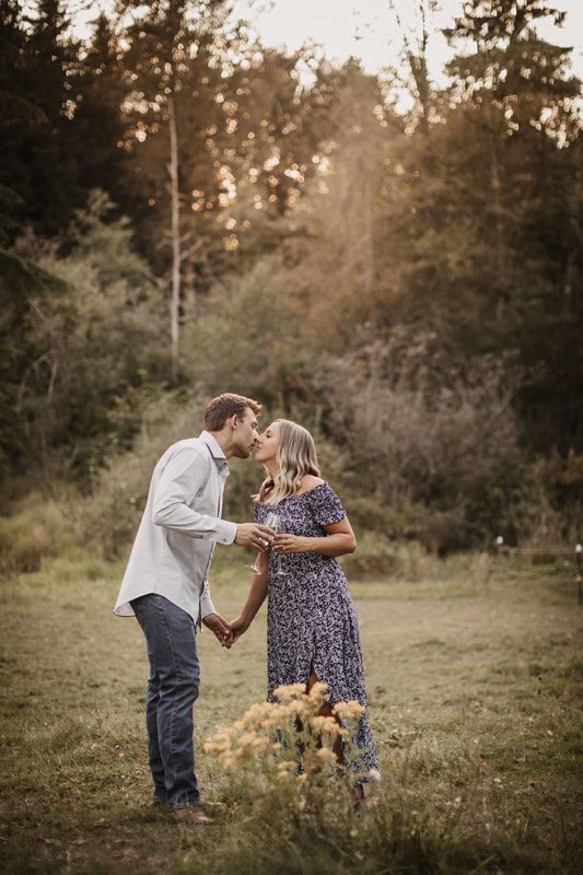 Close-up of the couple's hands and engagement ring on the farm