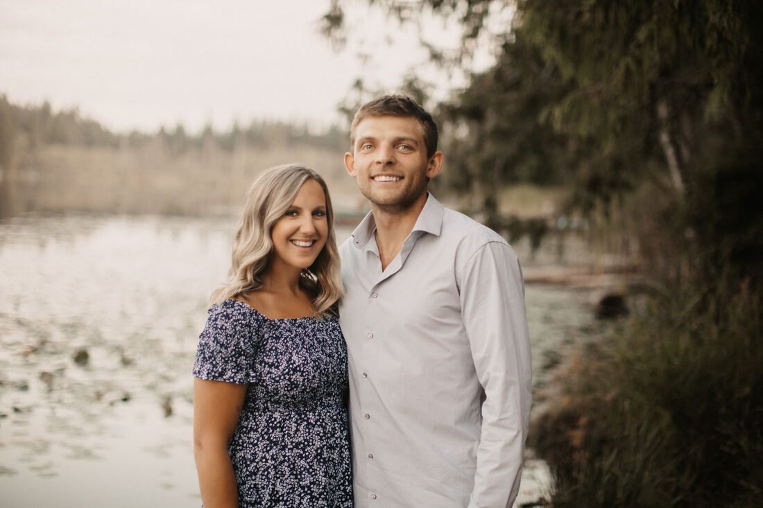 Engaged couple walking through a wildflower field near Snohomish