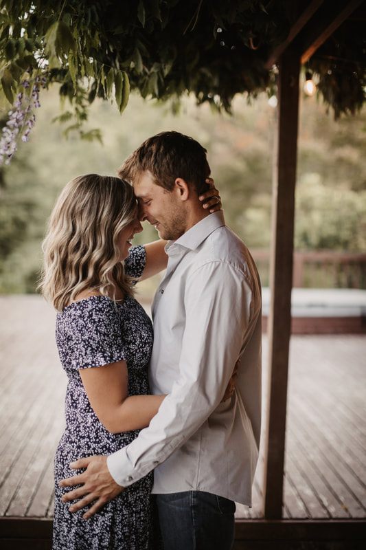 Couple laughing together beside a farm gate
