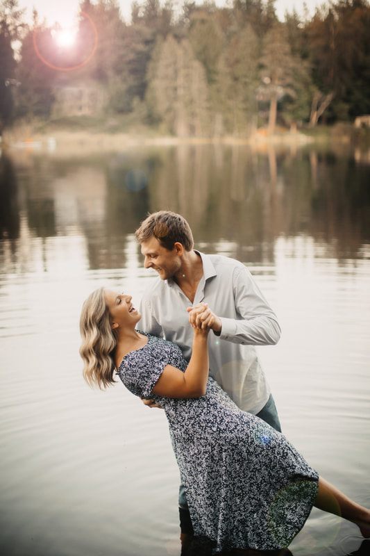 Engaged couple embracing near their barn at dusk