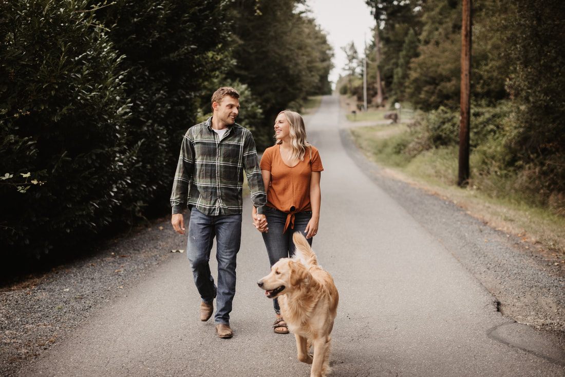 Couple walking together through a grassy farm field