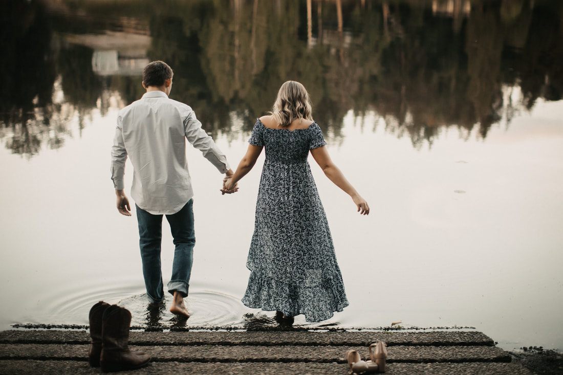 Couple sharing a close moment in front of farm equipment