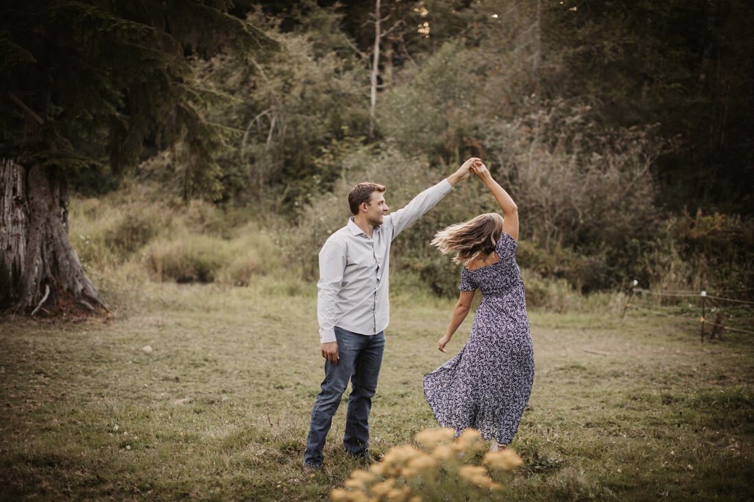 Engaged couple portrait framed by farm fencing