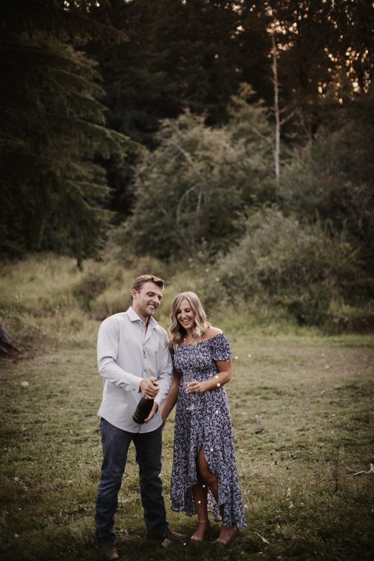Couple laughing together beside a farm truck