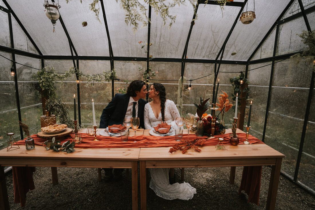 Rainy forest backdrop behind an eloping couple at the PNW cabin