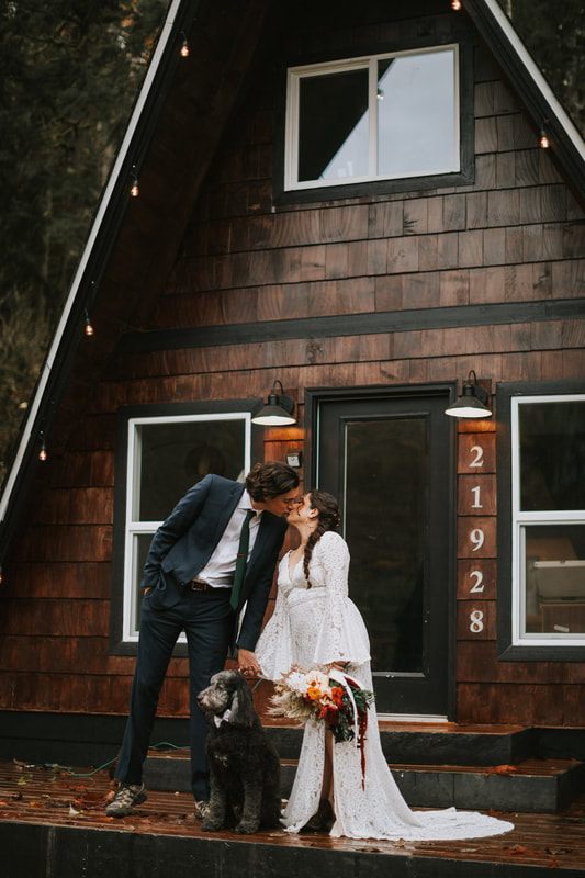 Bride and groom laughing together despite the rainy weather