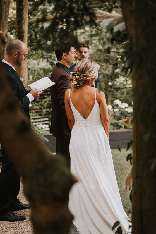 The newlyweds gathered for portraits beneath string lights at the reception