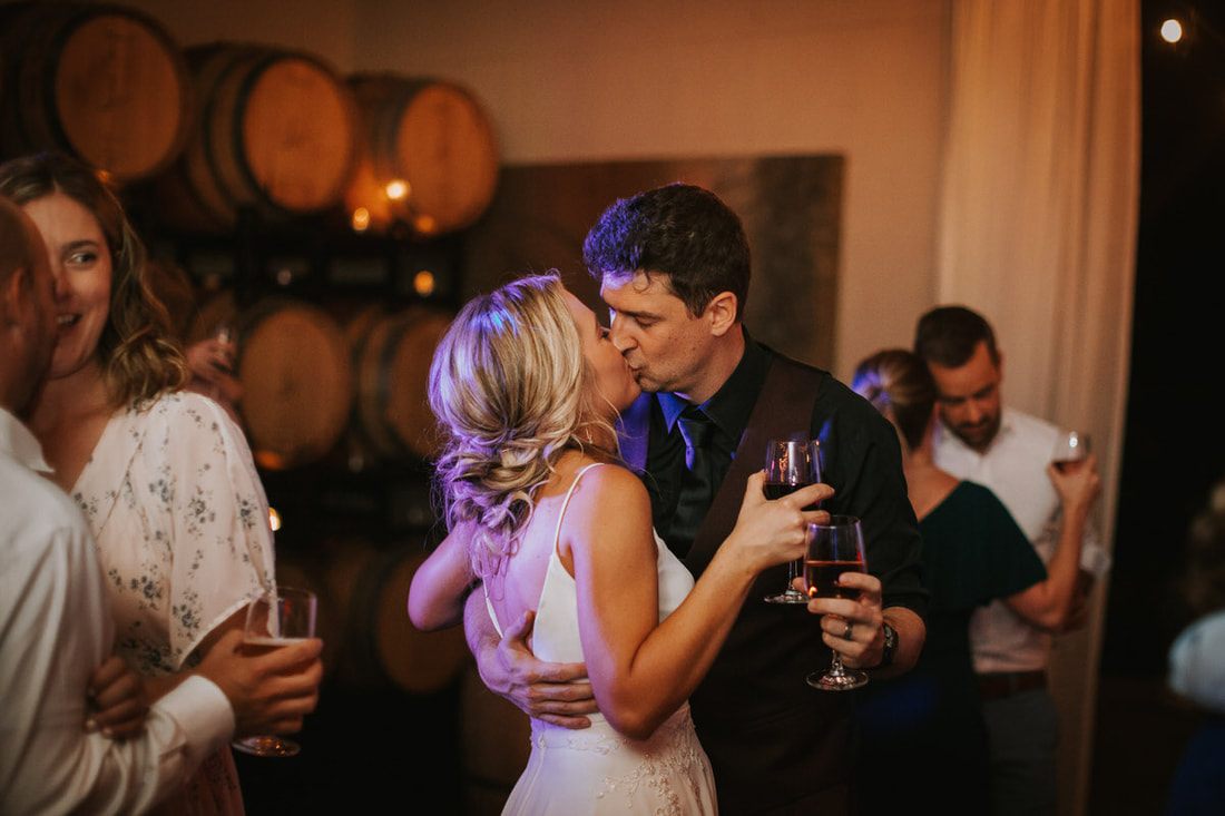 Katie and Alex sharing a quiet moment beneath string lights at the reception