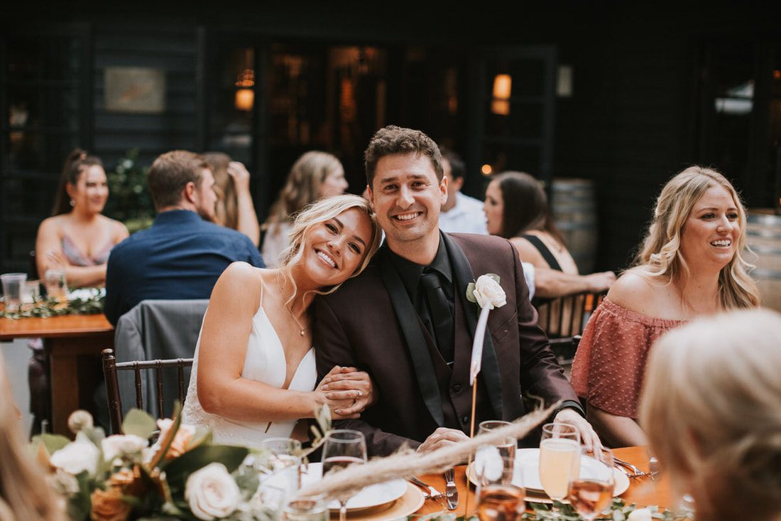 Katie and Alex celebrating with friends at JM Cellars winery in Woodinville