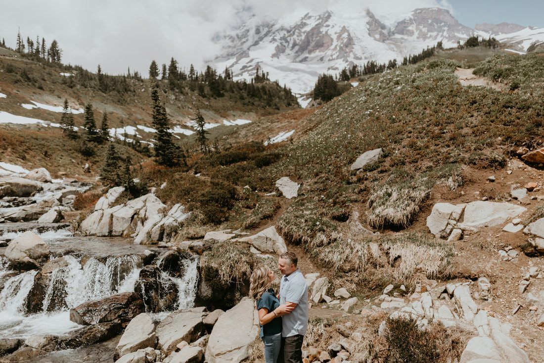 Couple walking hand in hand along a trail near Mt. Rainier