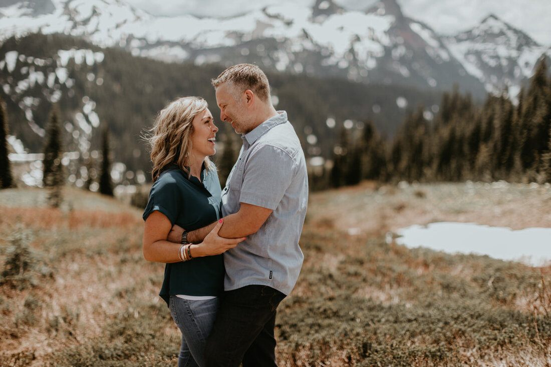 Engagement portrait with dramatic alpine scenery behind the couple