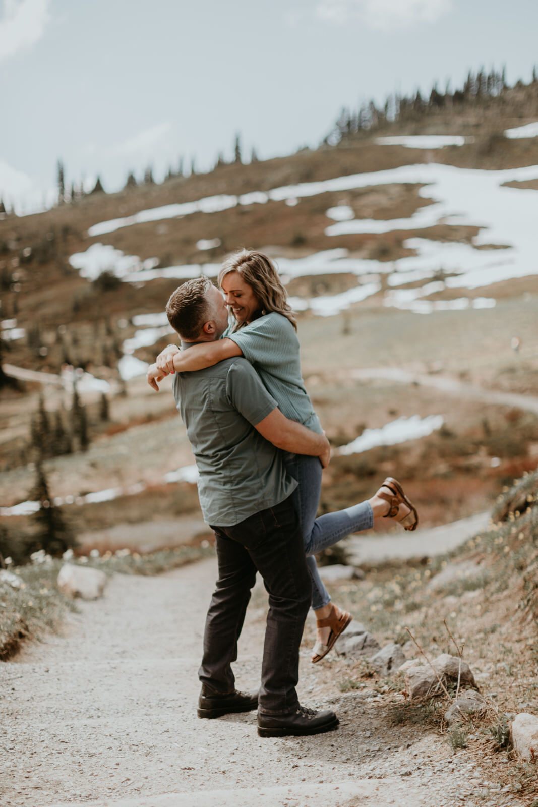 Couple embracing with Mt. Rainier's peak visible in the distance