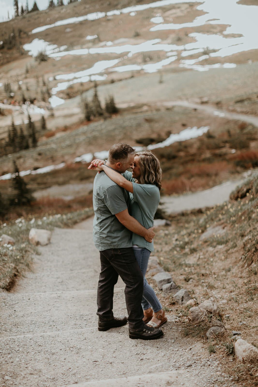 Engagement portrait in soft midday light near the mountain