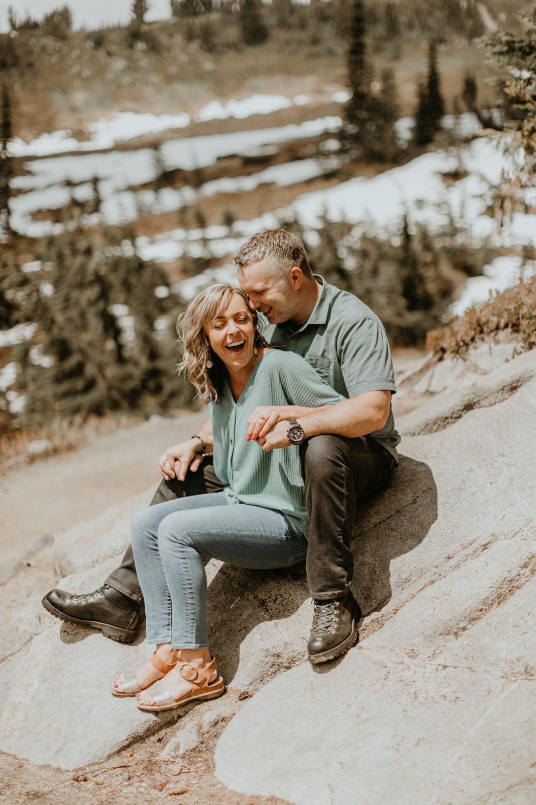 Wide landscape shot featuring the couple and Mt. Rainier
