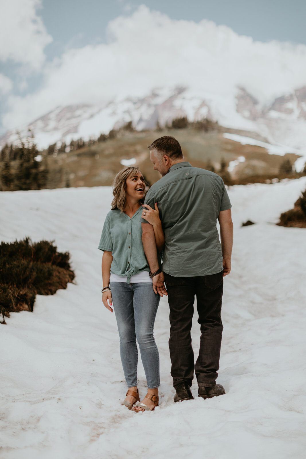 Engagement portrait with the couple silhouetted against the sky