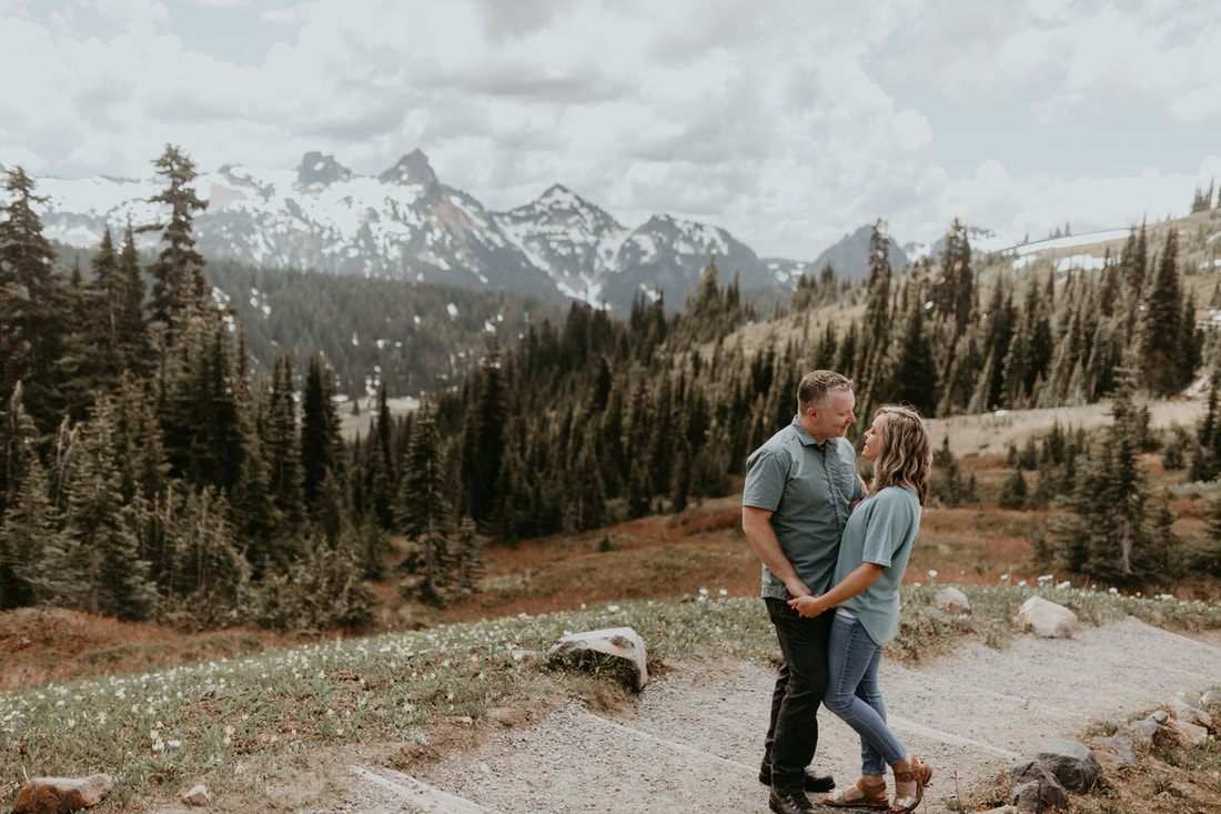Wide shot of the couple against the Mt. Rainier landscape