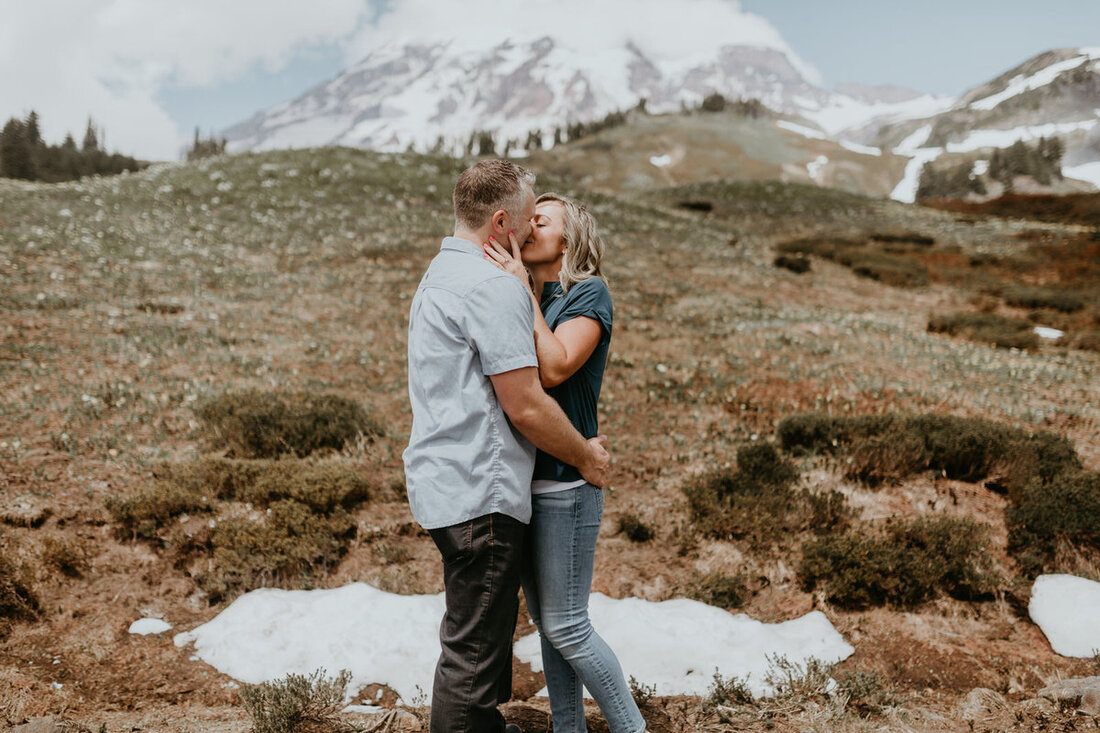 Portrait of the couple walking through alpine wildflowers