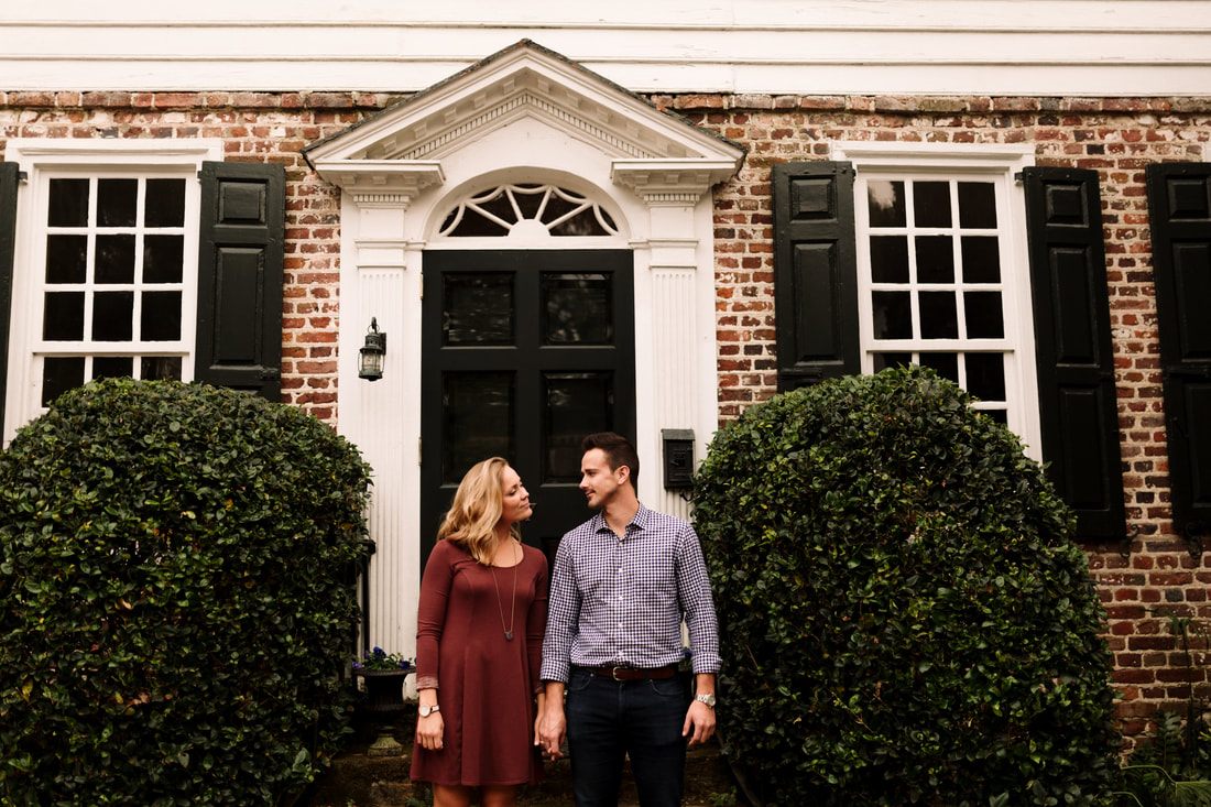 Madison and Ashley walking hand in hand through downtown Charleston