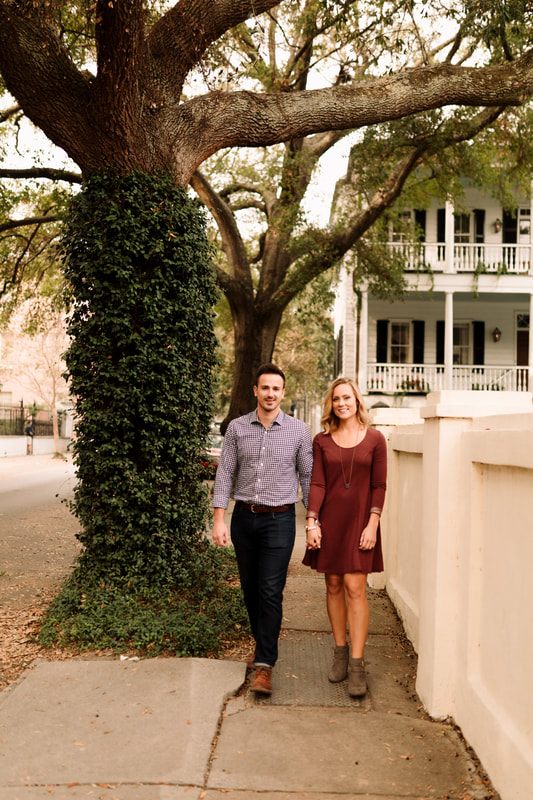 Madison and Ashley sharing a kiss on a cobblestone Charleston street