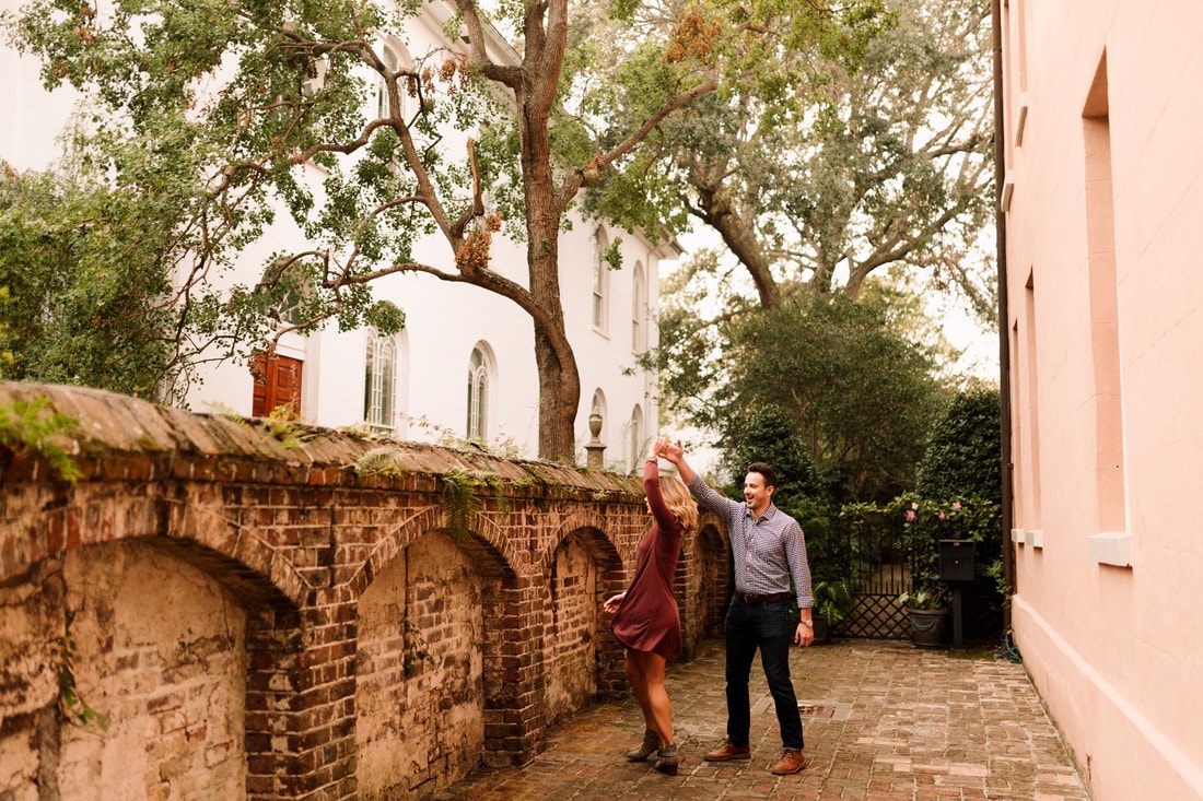 Close-up of the couple's clasped hands walking through downtown Charleston