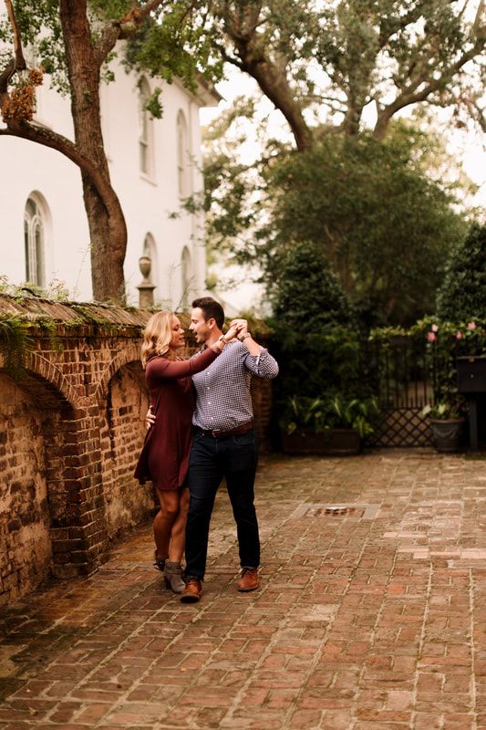 Madison and Ashley posed in front of a wrought-iron gate in Charleston