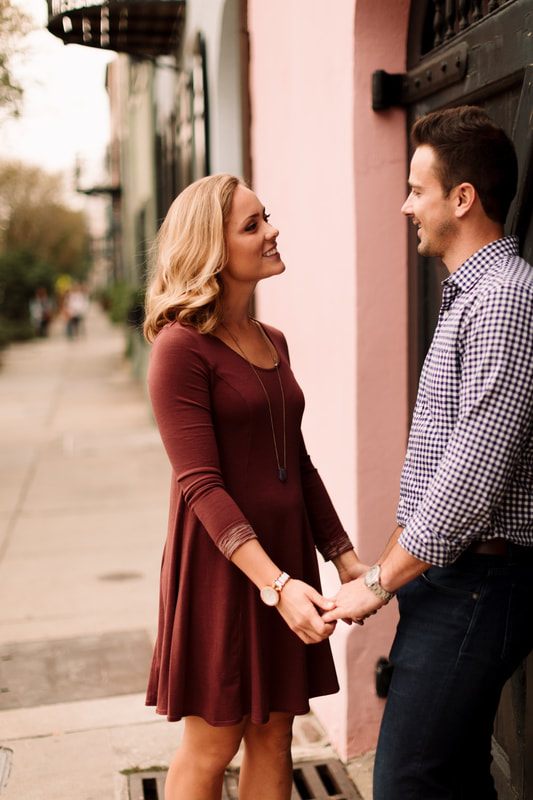 Engagement portrait of the couple beneath Charleston's historic architecture