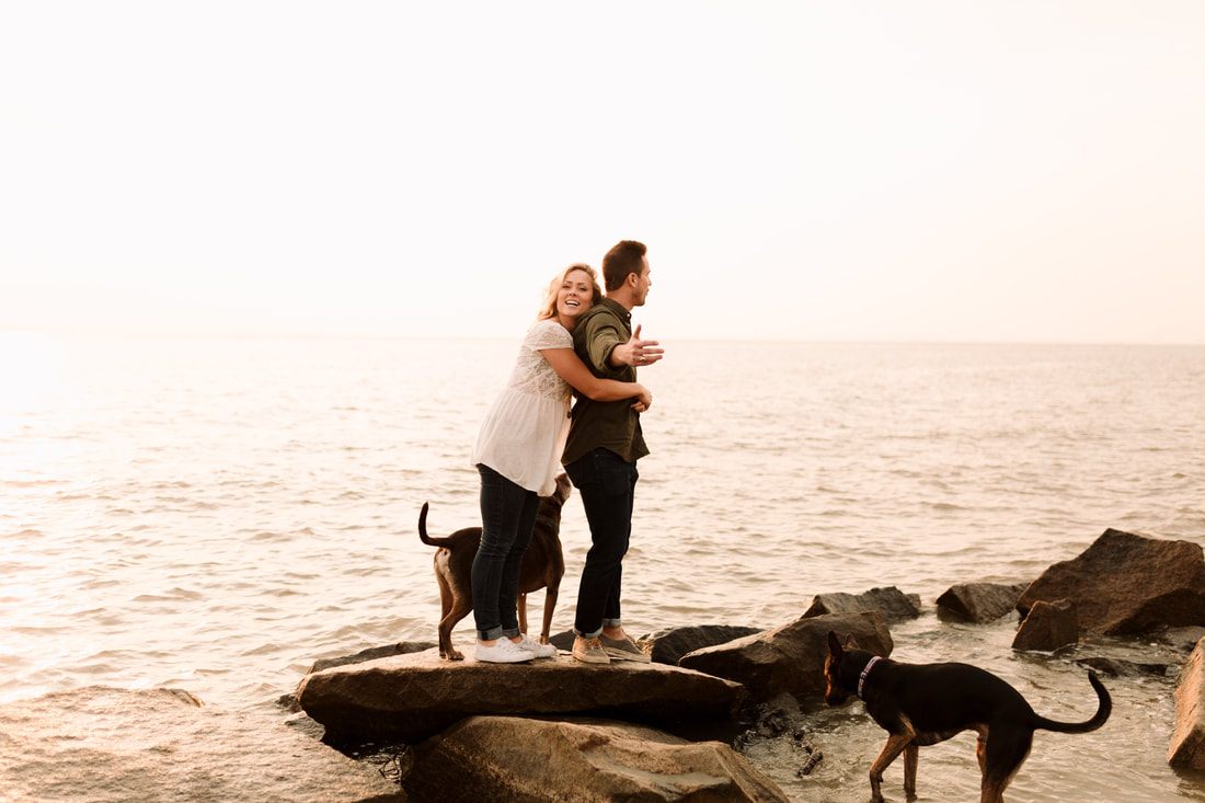 Madison and Ashley playing with their dogs on the beach