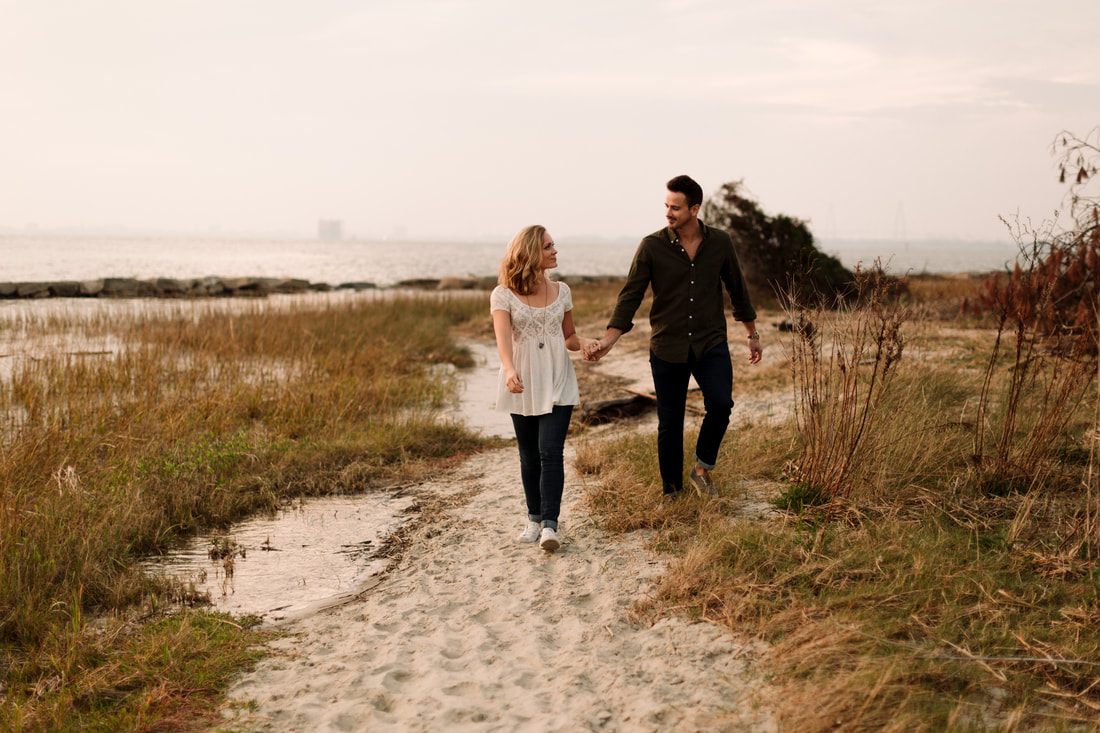 Close-up engagement portrait of the couple against a historic Charleston facade