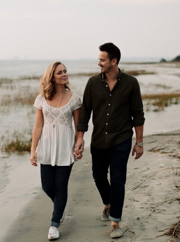 Golden hour portrait of the couple walking along the Sullivan's Island shoreline