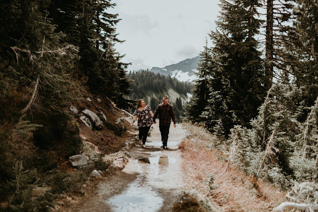Close-up portrait of an engaged couple with the mountain glacier behind them