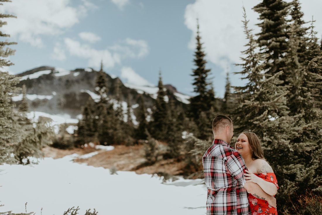 Couple walking away hand in hand toward the mountain at golden hour