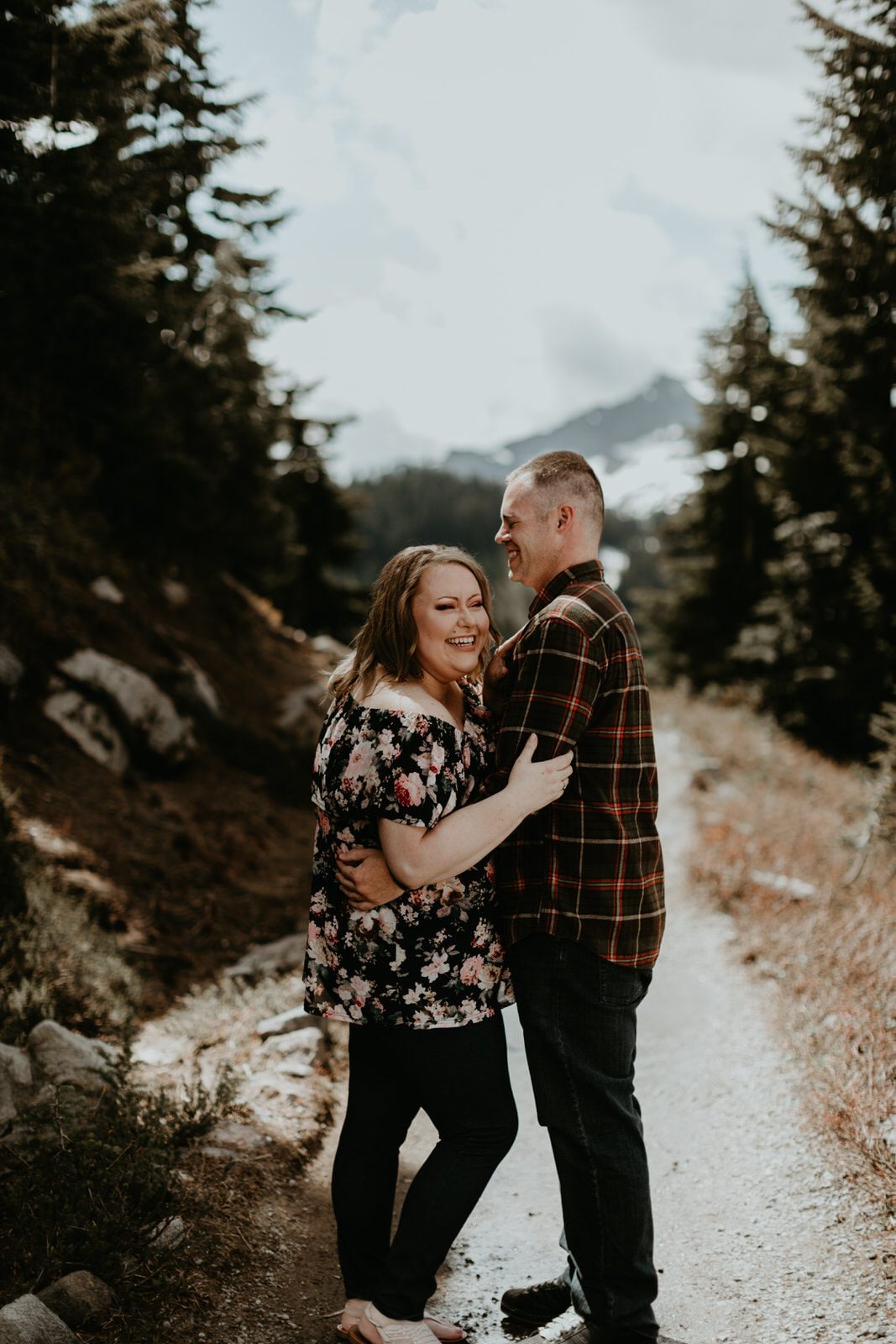 Couple walking hand in hand through a Mt. Rainier National Park meadow