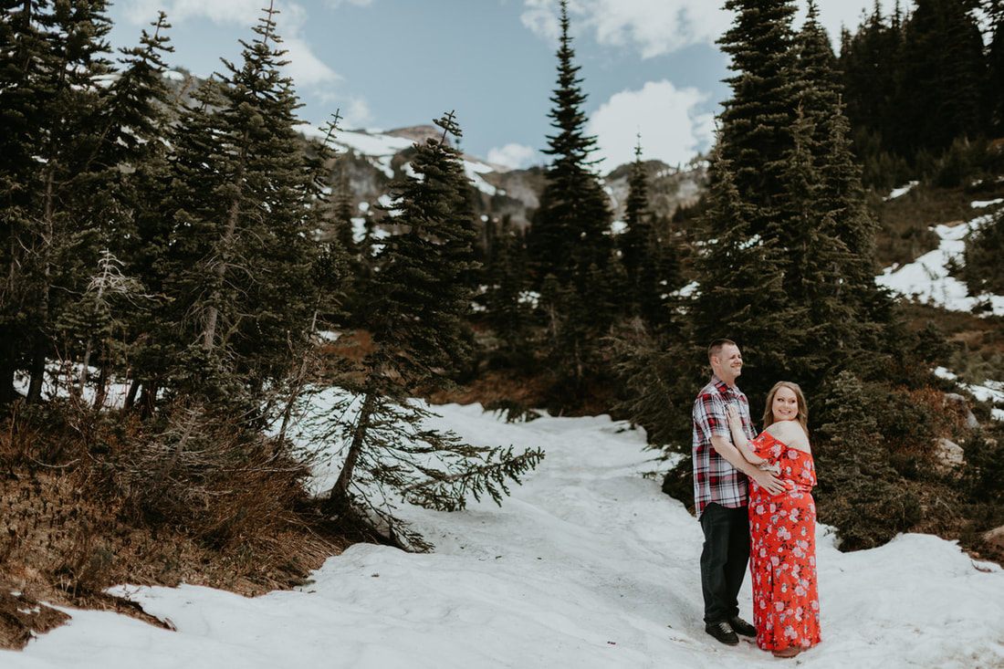 Engaged couple portrait with glacier-capped Mt. Rainier in the distance