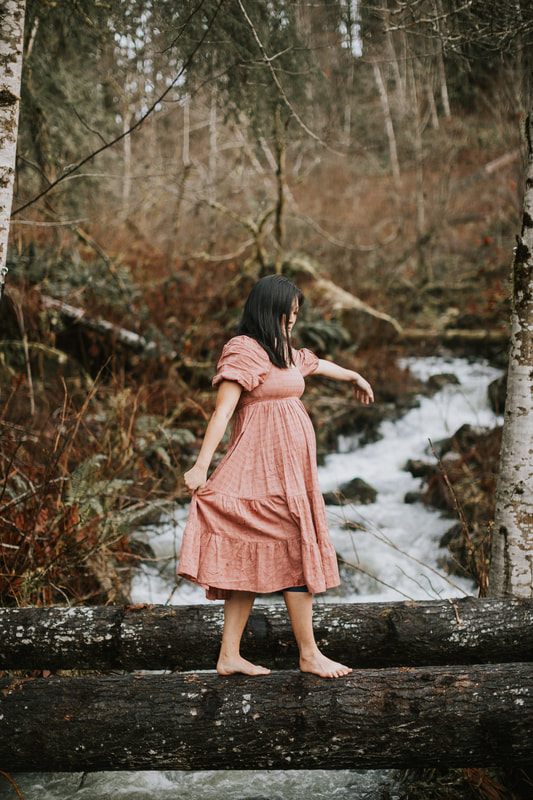 Two expecting best friends walking together through the misty forest