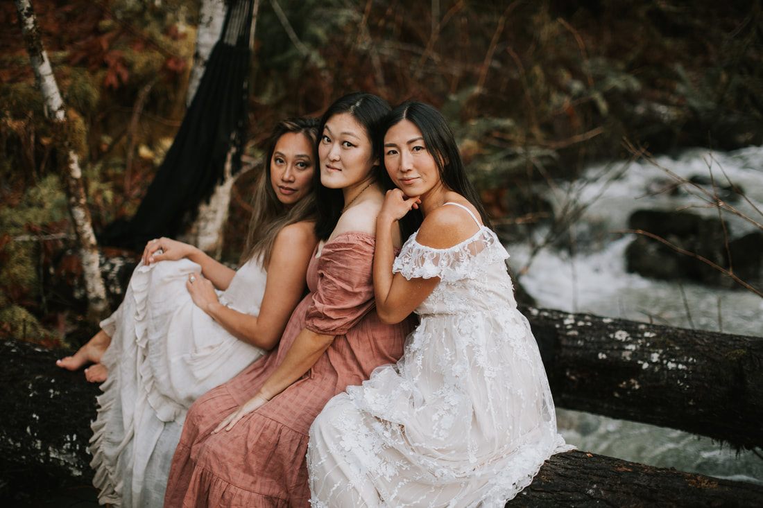 Candid portrait of friends embracing near the creek by the cabin