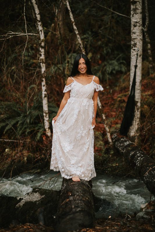 Maternity portrait of a mother-to-be smiling in the rain