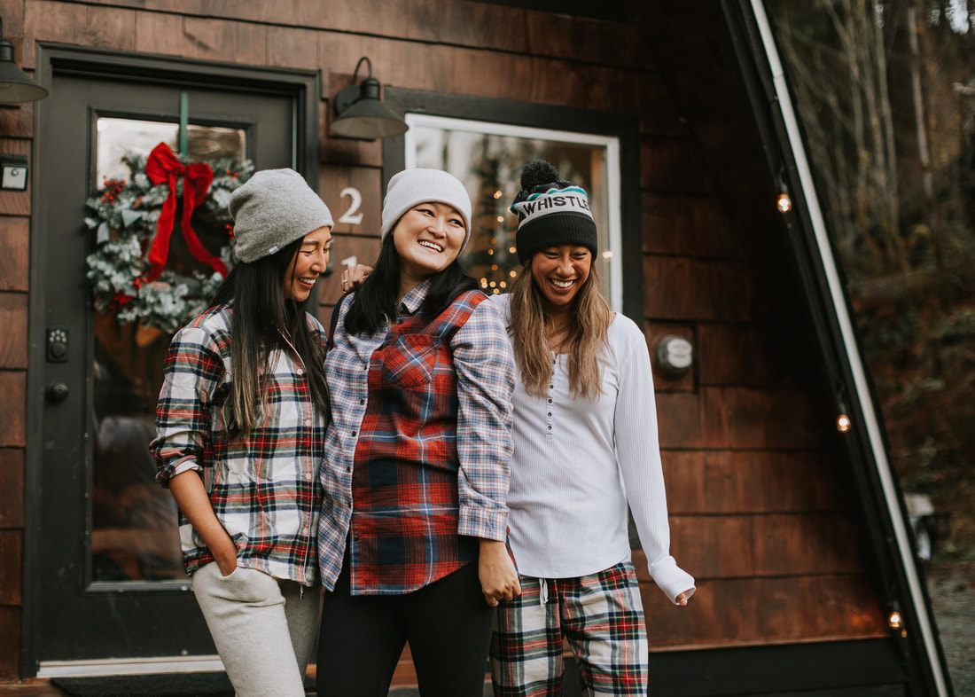 Three best friends sharing a group hug at the cabin