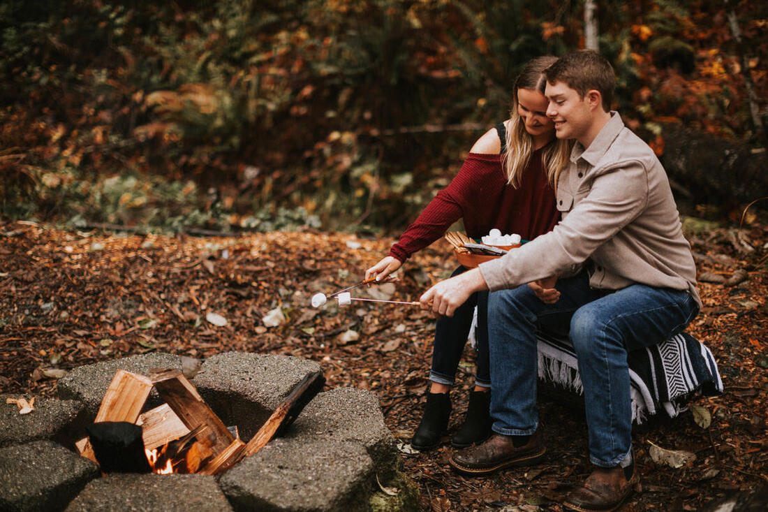 Engaged couple snuggled together on the couch at That PNW Cabin
