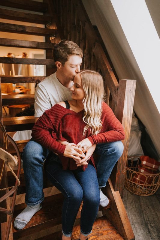 Couple standing outside the A-frame cabin in the Cascade Mountains